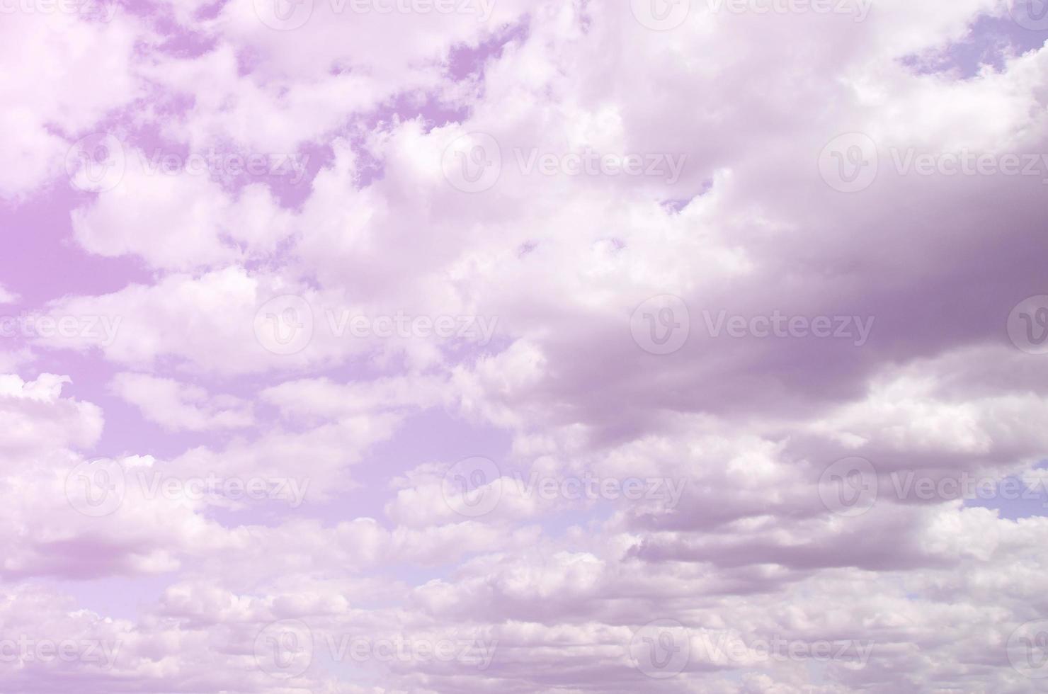 A blue sky with lots of white clouds of different sizes photo