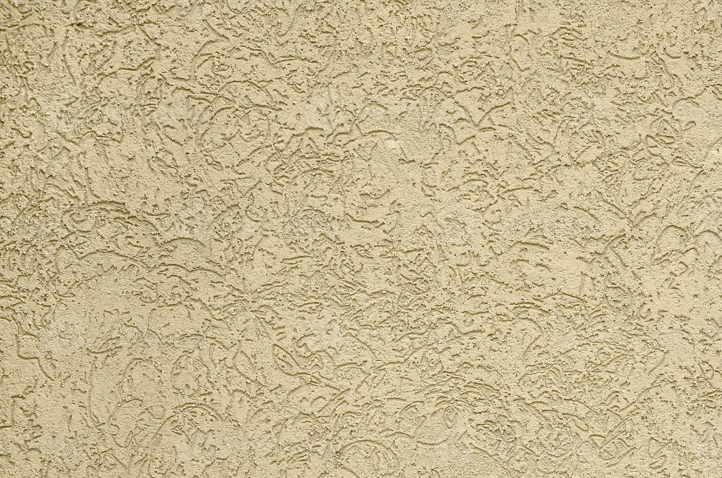 The texture of the beige decorative plaster in bark beetle style photo