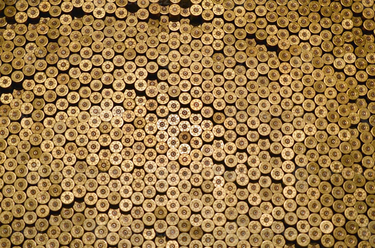 Pattern of 12 gauge cartridges for shotgun bullets. Shells for hunting rifle close up. Backdrop for shooting range or ammunition trade concepts photo