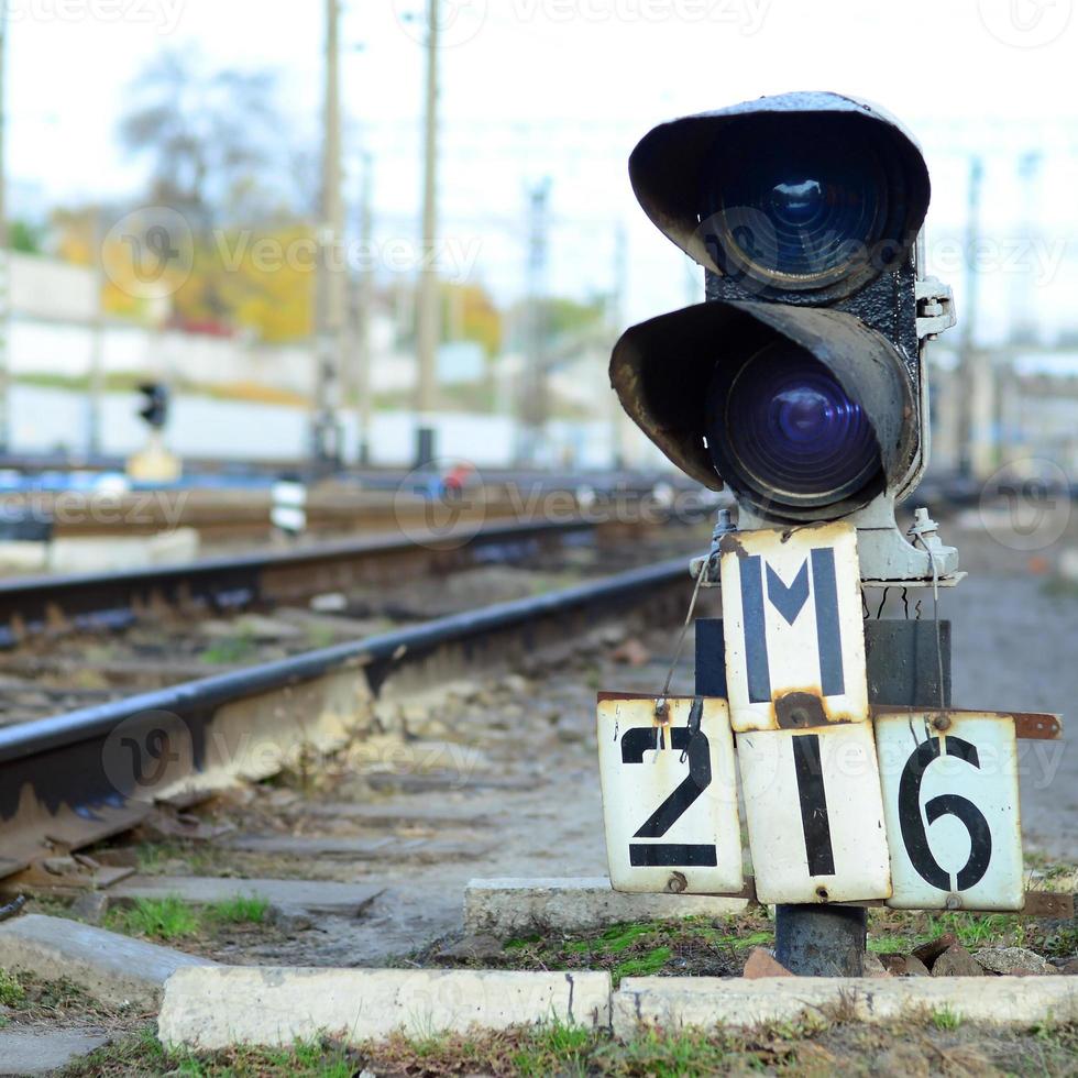 Semaphore with burning blue light. The intersection of railway tracks photo