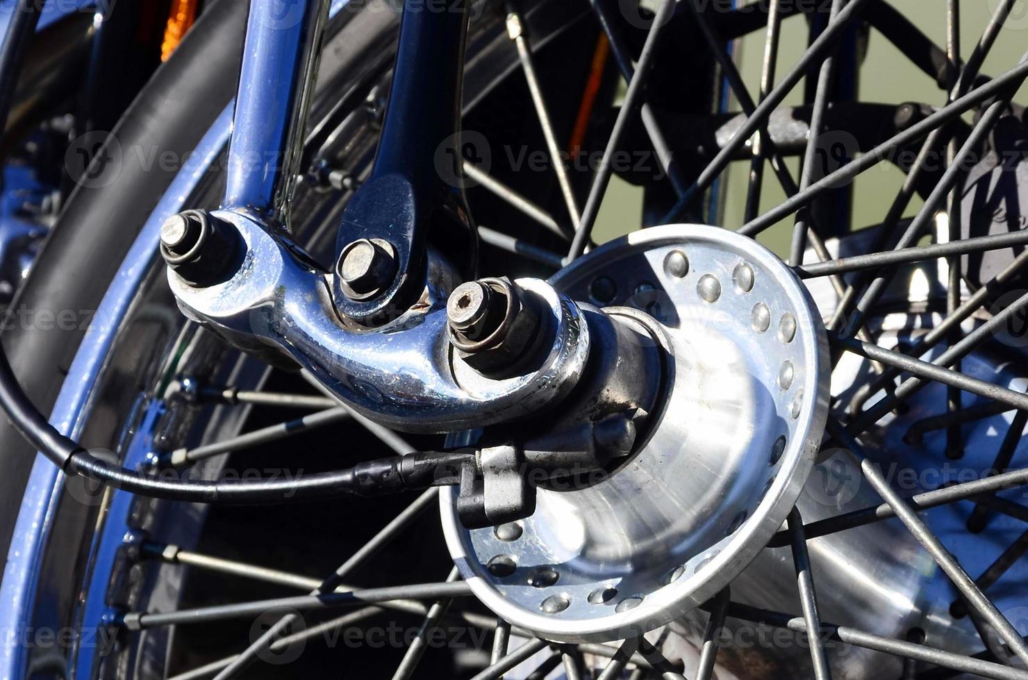 Fragment of chromed shiny wheel of old classic motorbike photo