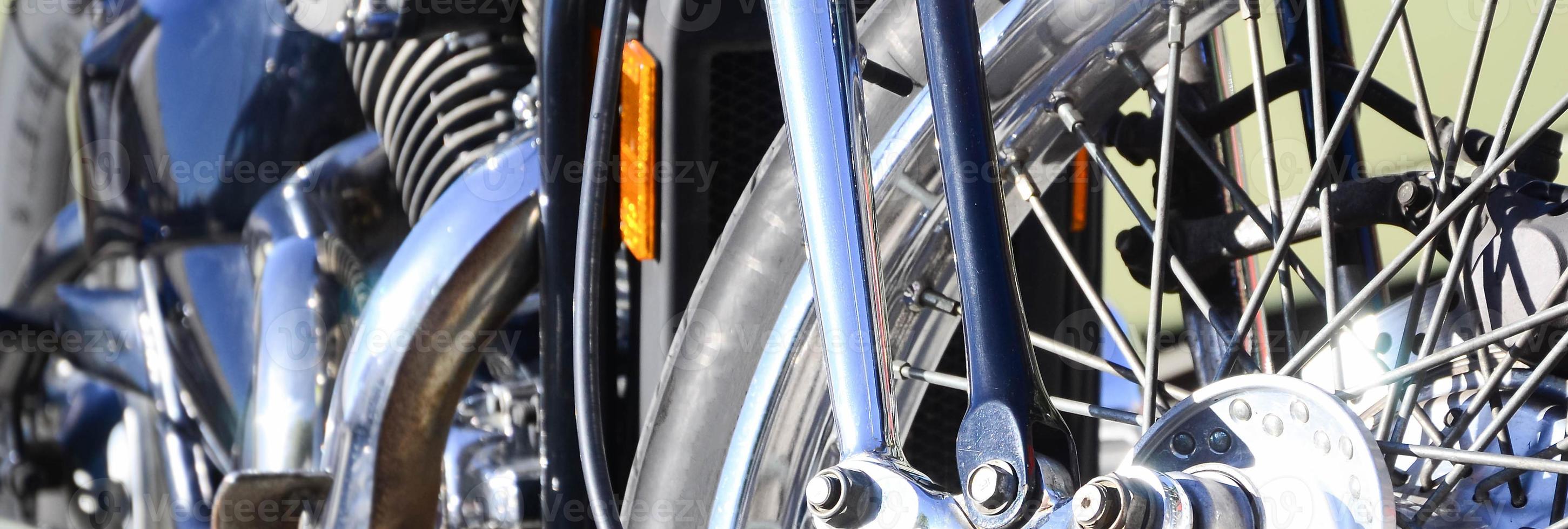 Fragment of chromed shiny wheel of old classic motorbike photo