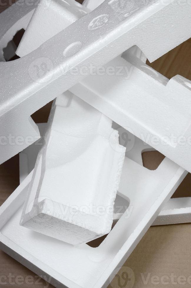 Background image with beige cardboard paper and styrofoam boxes disgarded as rubbish. The concept of unpacking new home appliances out of the carton box photo
