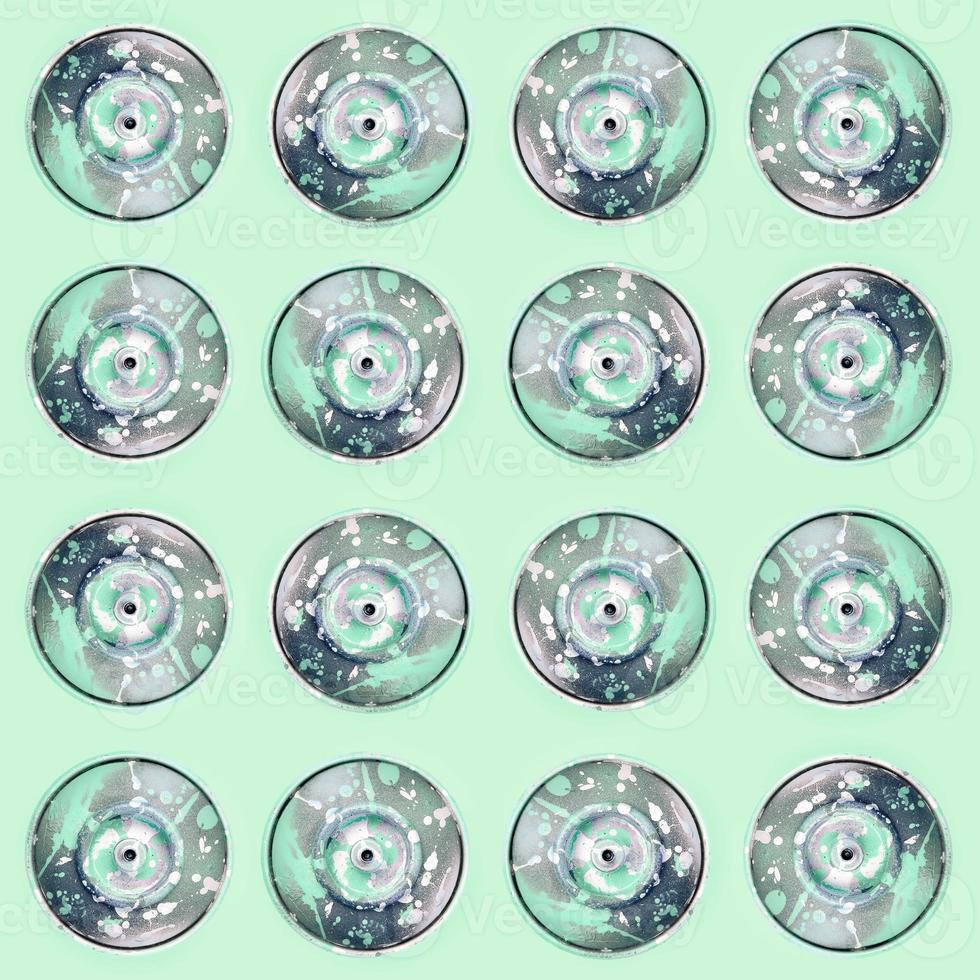 Many used spray cans for graffiti drawing lies on a pastel colored backgroung. Street art painting concept. Minimal flat lay pattern. Top view photo
