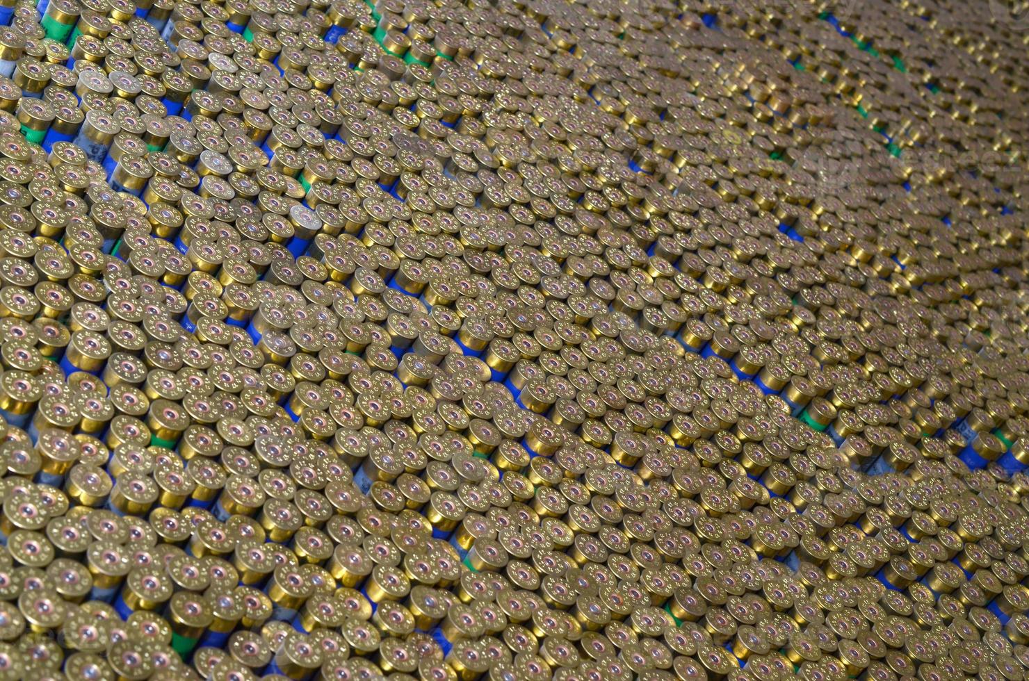 Pattern of 12 gauge cartridges for shotgun bullets. Shells for hunting rifle close up. Backdrop for shooting range or ammunition trade concepts photo