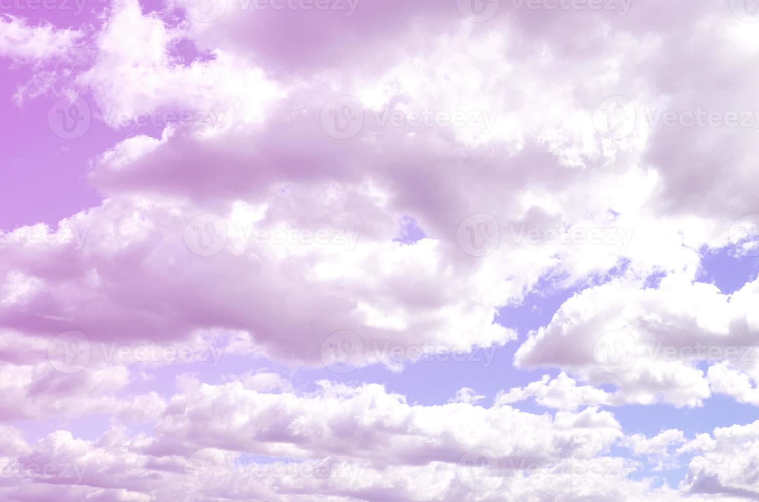 A blue sky with lots of white clouds of different sizes photo