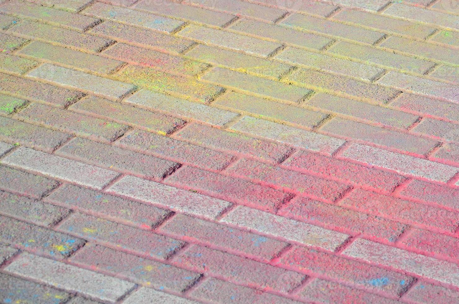 Multi colored paving slabs, powder coated with dry colors at the Holi festival photo