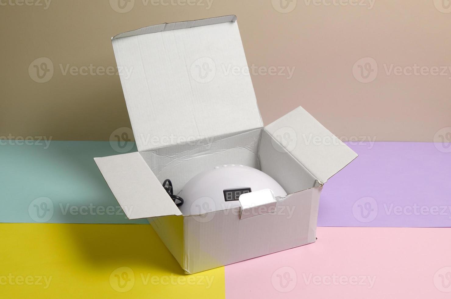 Unboxing of new UV LED nail lamp for curing process by gel method photo