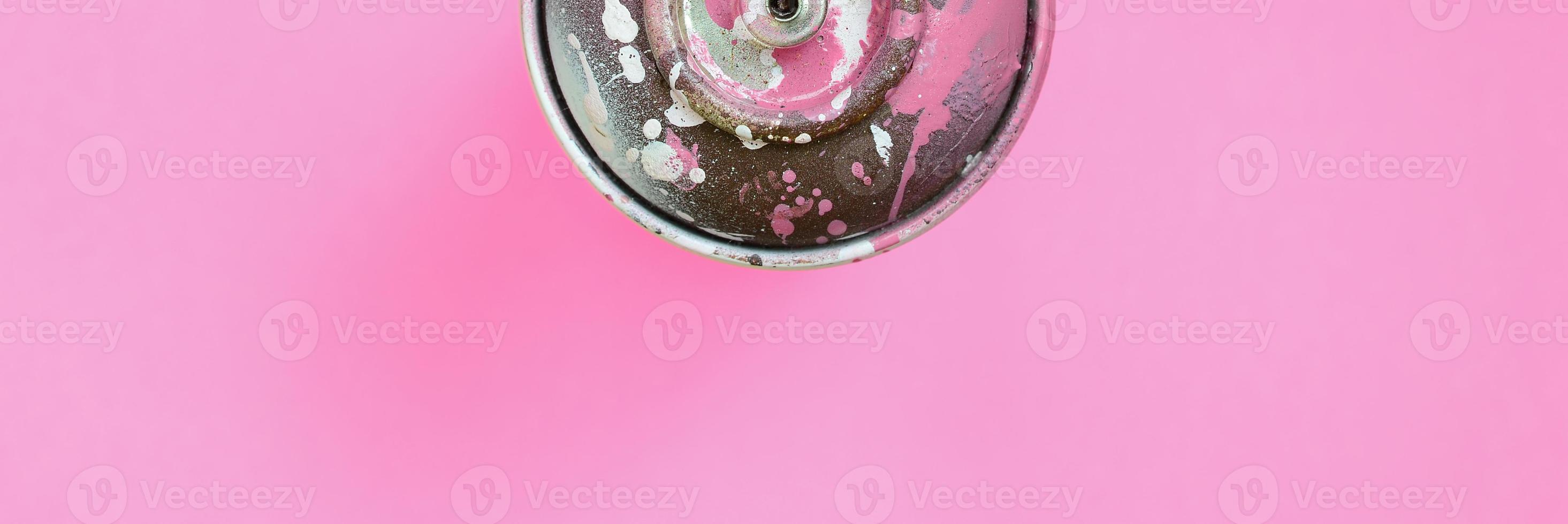 Used spray can with pink paint drips lie on texture background of fashion pastel pink color paper in minimal concept photo