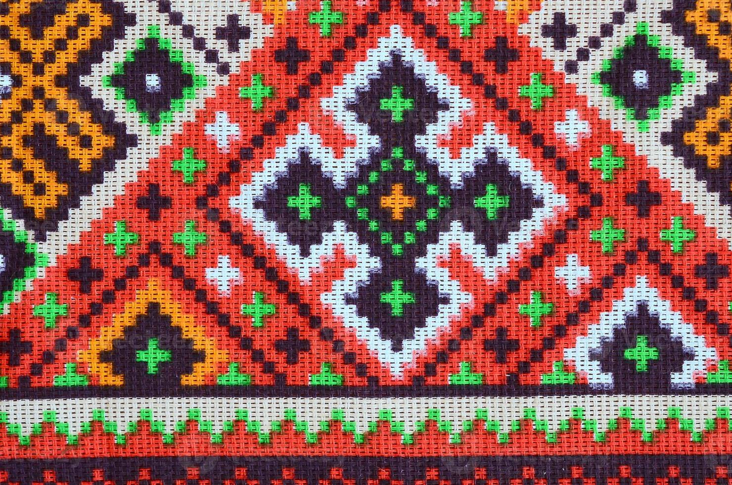 Traditional Ukrainian folk art knitted embroidery pattern on textile fabric photo