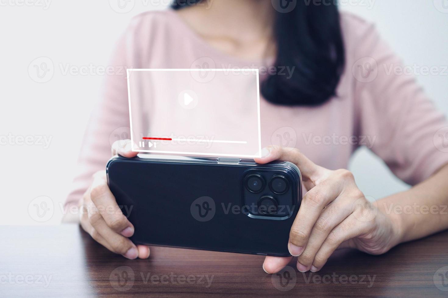 woman watching video on mobile phone for entertainment. photo