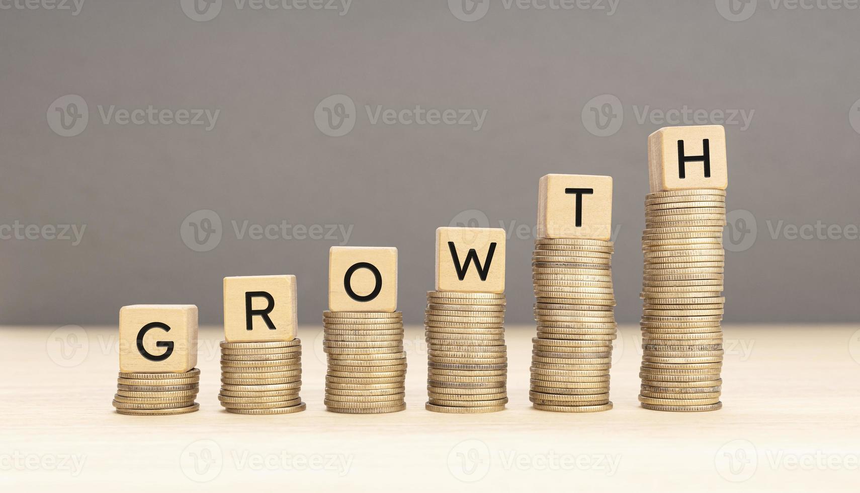 Money or revenue Growth concept. Stacking coins and wooden blocks with text. Copy space photo