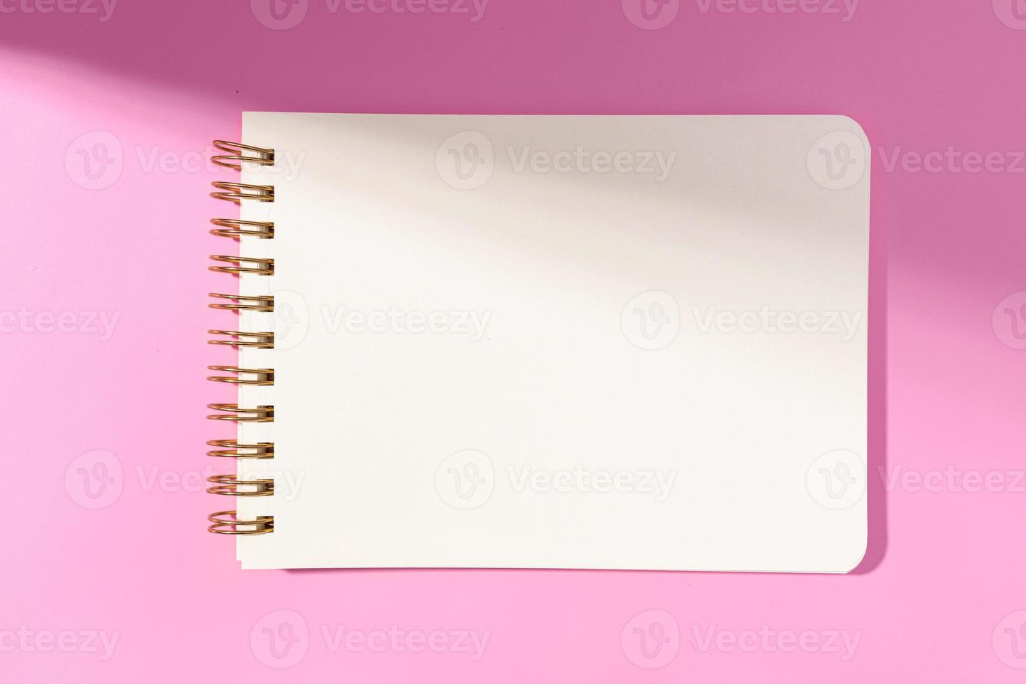 Blank white paper notebook Isolated on pink background. Template mock up photo