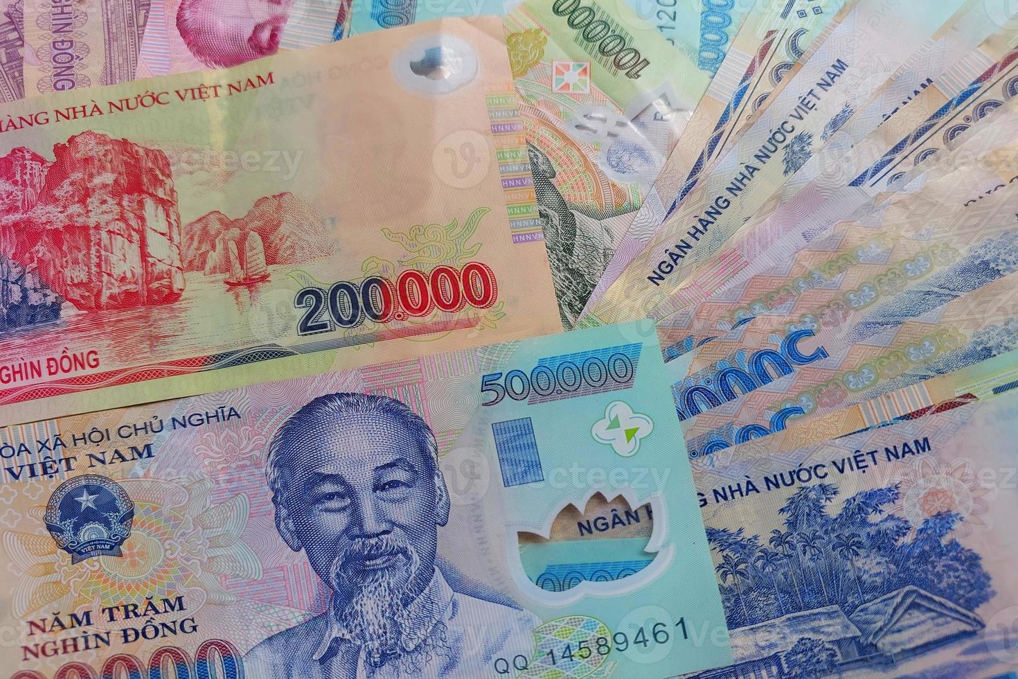 Vietnamese dong banknotes close-up. Money background. Vietnamese currency - dongs. Pattern texture and background of Vietnam dong money, currency banknotes ready for exchange and business investment photo