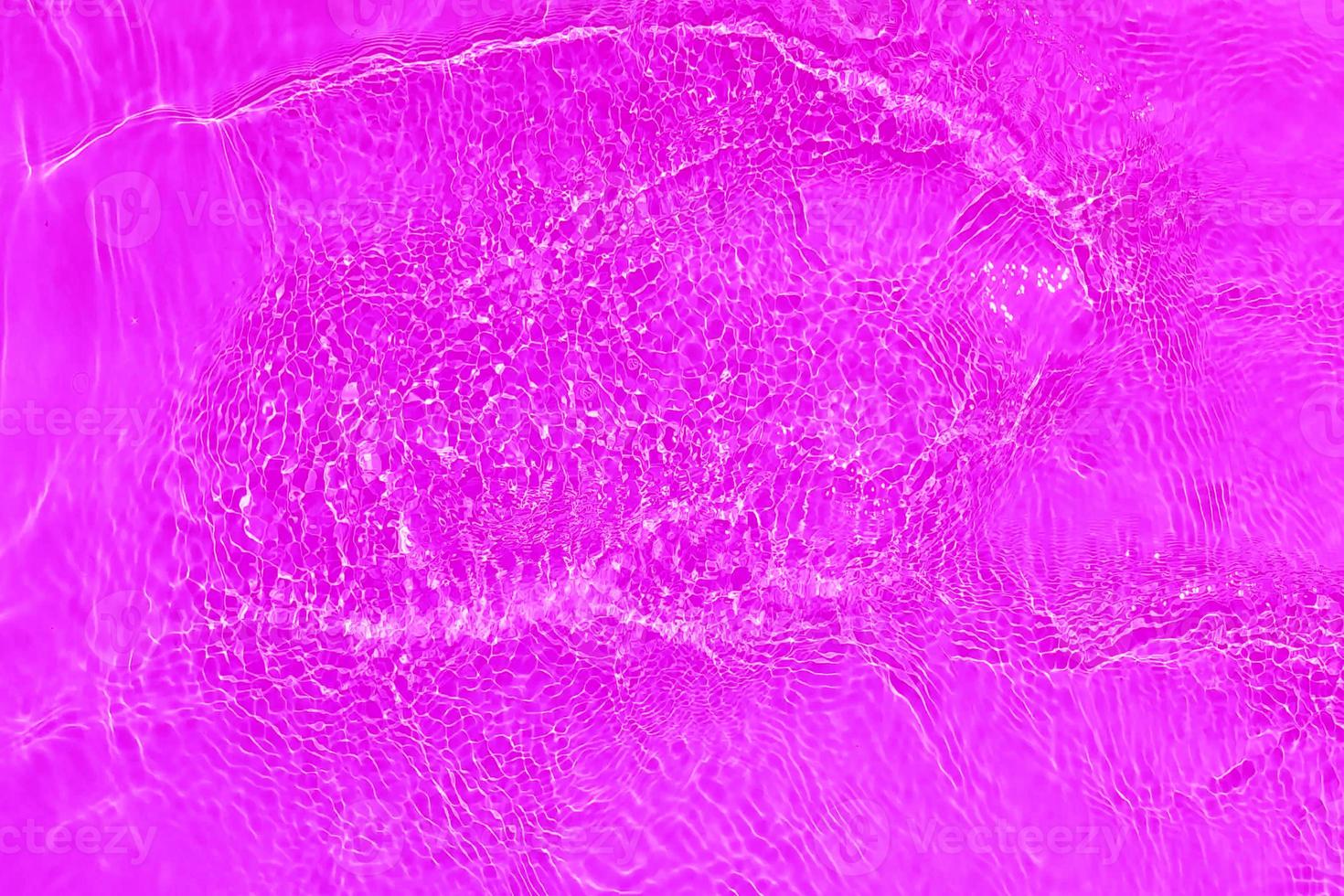 Defocus blurred transparent gold colored clear calm water surface texture with splashes and bubbles. Trendy abstract nature background. Water waves in sunlight with copy space. Gold watercolor shining photo