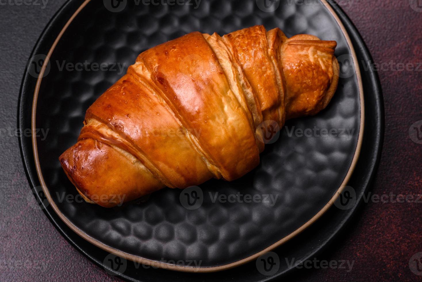 Beautiful different Christmas decorations and croissant on a brown concrete table photo