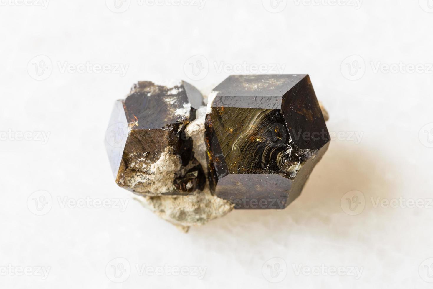 rough Andradite garnet rock on white marble photo