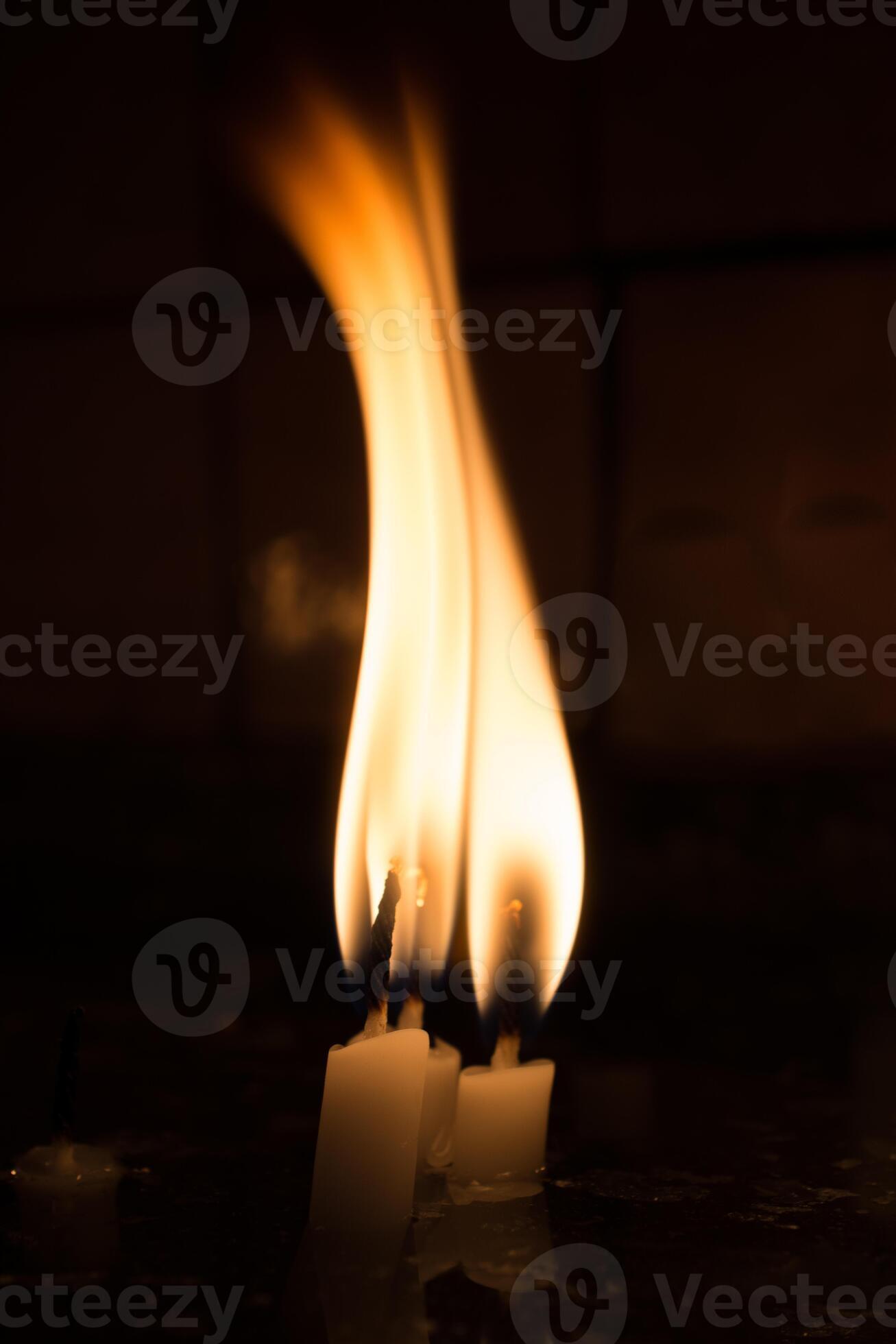 Burning candles give light in the dark 14500159 Stock Photo at Vecteezy