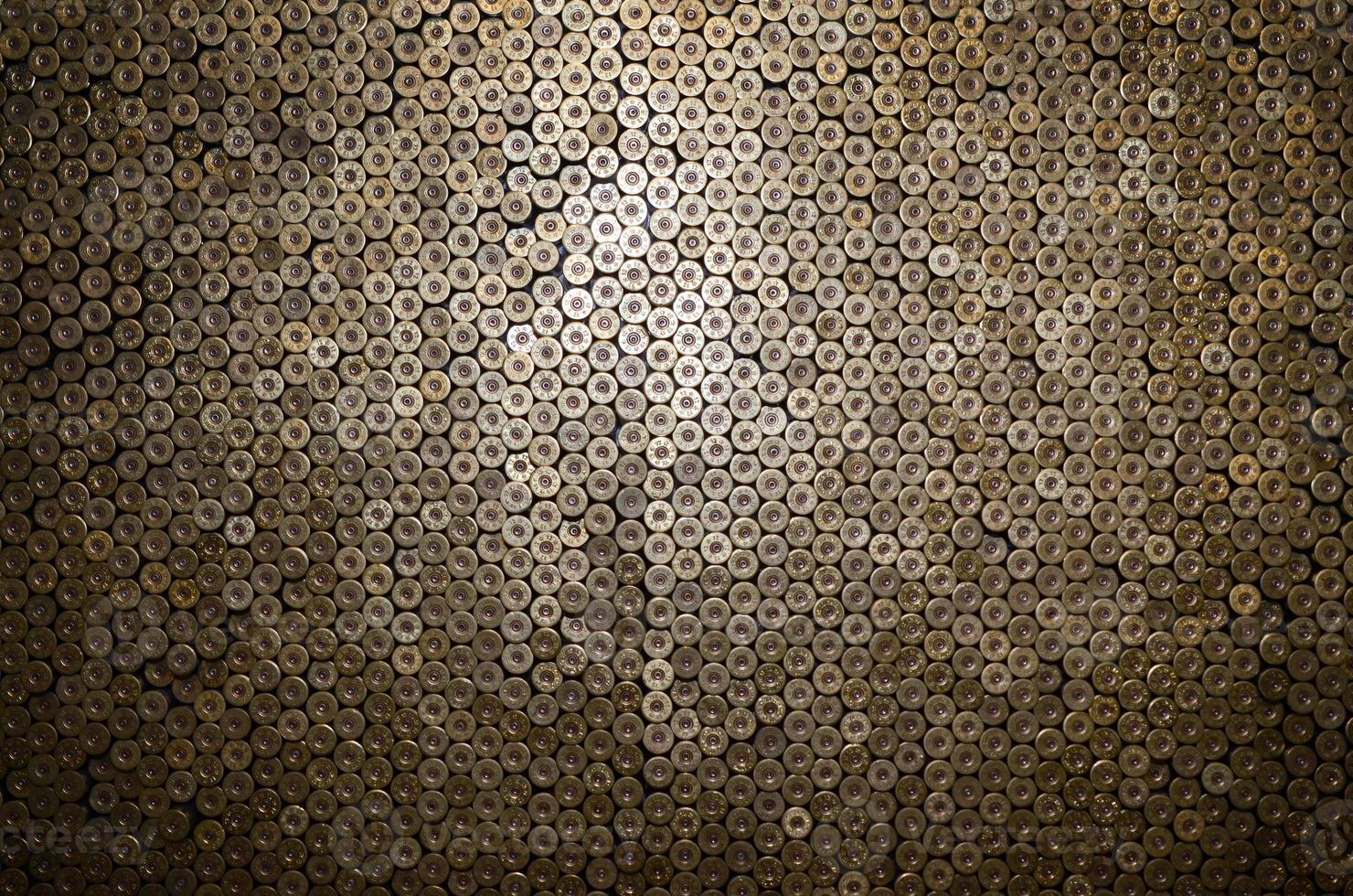 Pattern of 12 gauge cartridges for shotgun bullets. Shells for hunting rifle close up. Backdrop for shooting range or ammunition trade concepts photo