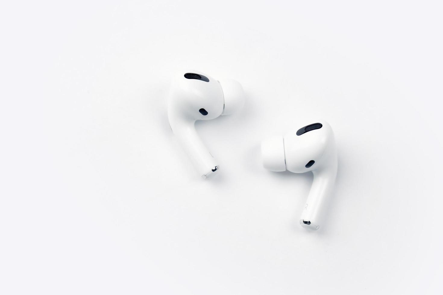 KHARKIV, UKRAINE - JANUARY 27, 2022 Apple AirPods Pro on a white background. Wireless headphones. Apple Inc. is an American technology company photo