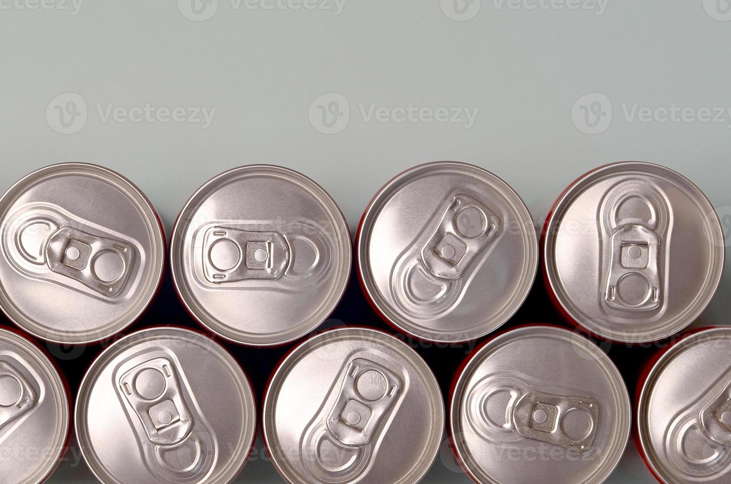 Many new aluminium cans of soda soft drink or energy drink containers. Drinks manufacturing concept and mass production photo