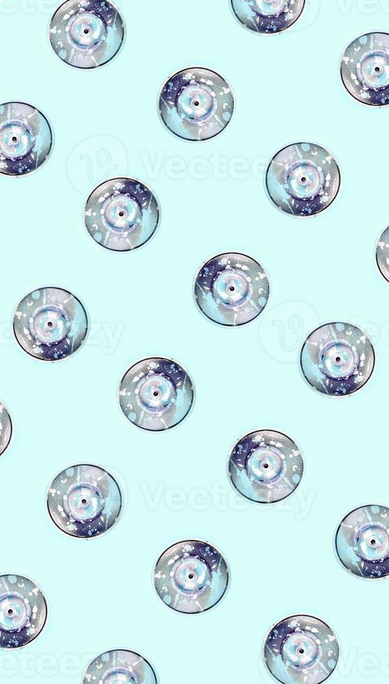Many used spray cans for graffiti drawing lies on a pastel colored backgroung. Street art painting concept. Minimal flat lay pattern. Top view photo