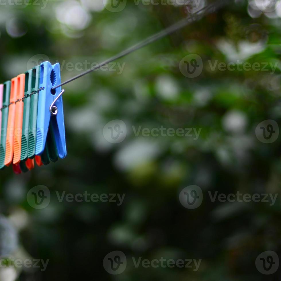 Clothespins on a rope hanging outside house and apple tree photo