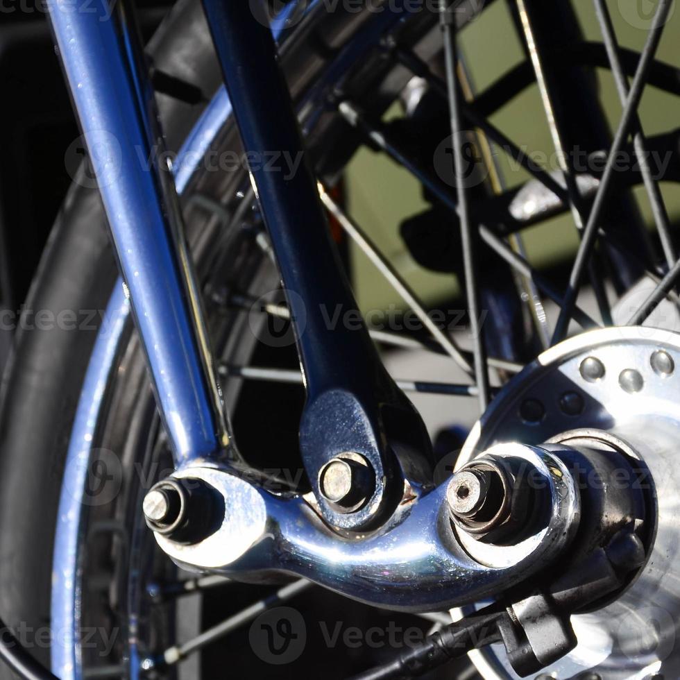 Fragment of chromed shiny wheel of old classic motorbike photo