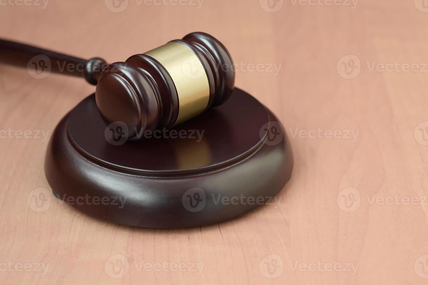 Justice mallet on wooden desk in a courtroom during a judicial trial. Law concept and empty space for text. Judge hammer photo