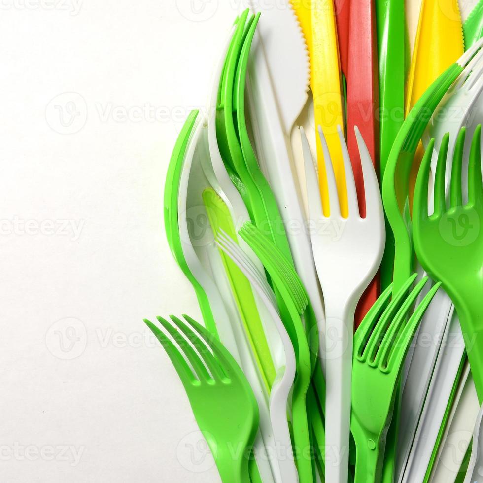 Pile of bright yellow, green and white plastic kitchenware single use