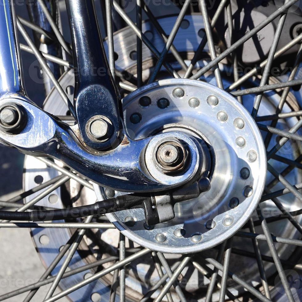 Fragment of chromed shiny wheel of old classic motorbike photo