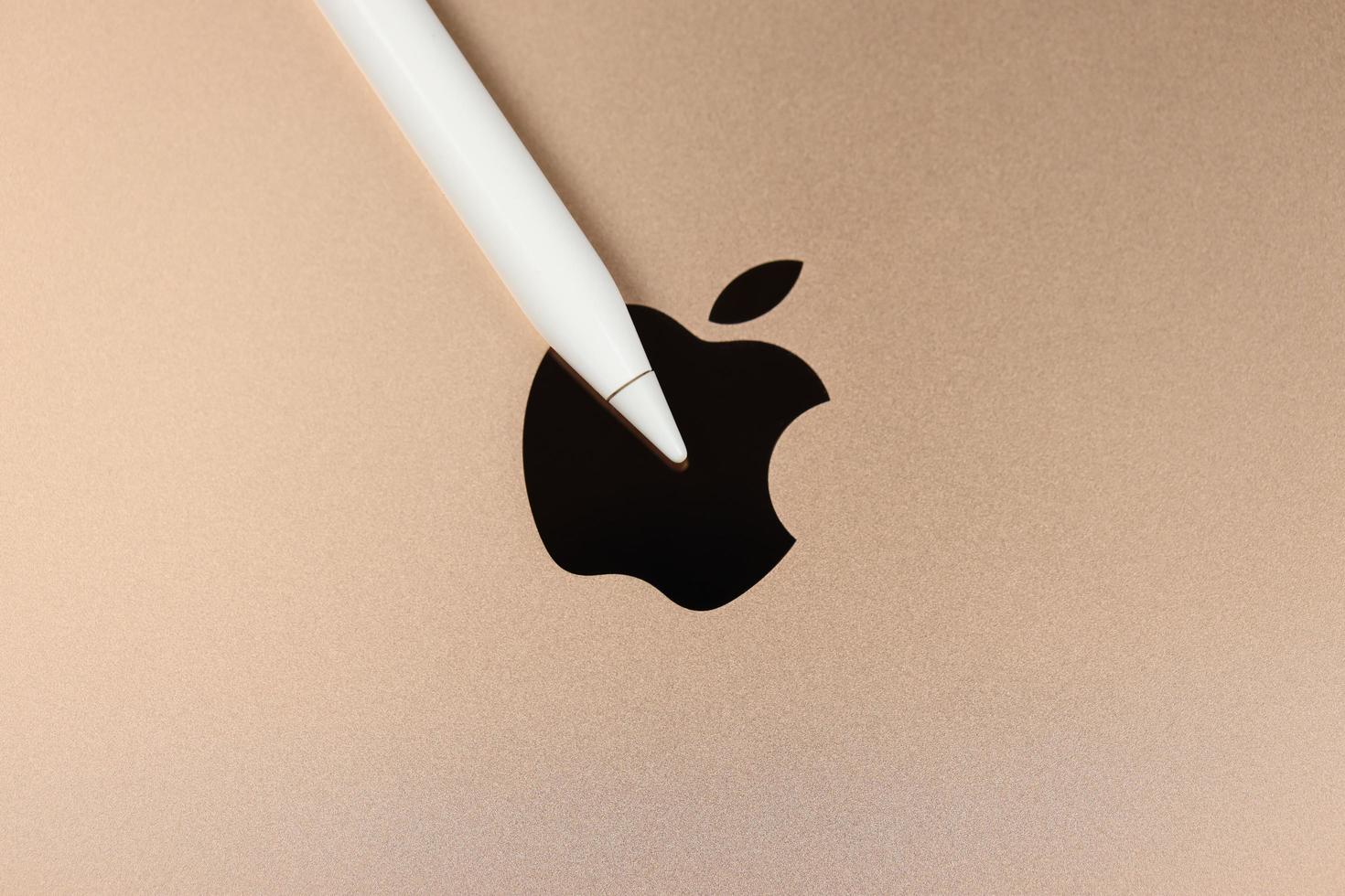 kharkiv, ucrania - 27 de enero de 2022 lápiz de manzana en la nueva superficie de cuerpo dorado de apple ipad con el logotipo de la empresa. Apple Inc. es una empresa de tecnología estadounidense con sede en california foto