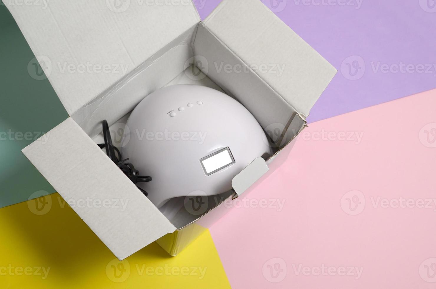 Unboxing of new UV LED nail lamp for curing process by gel method photo