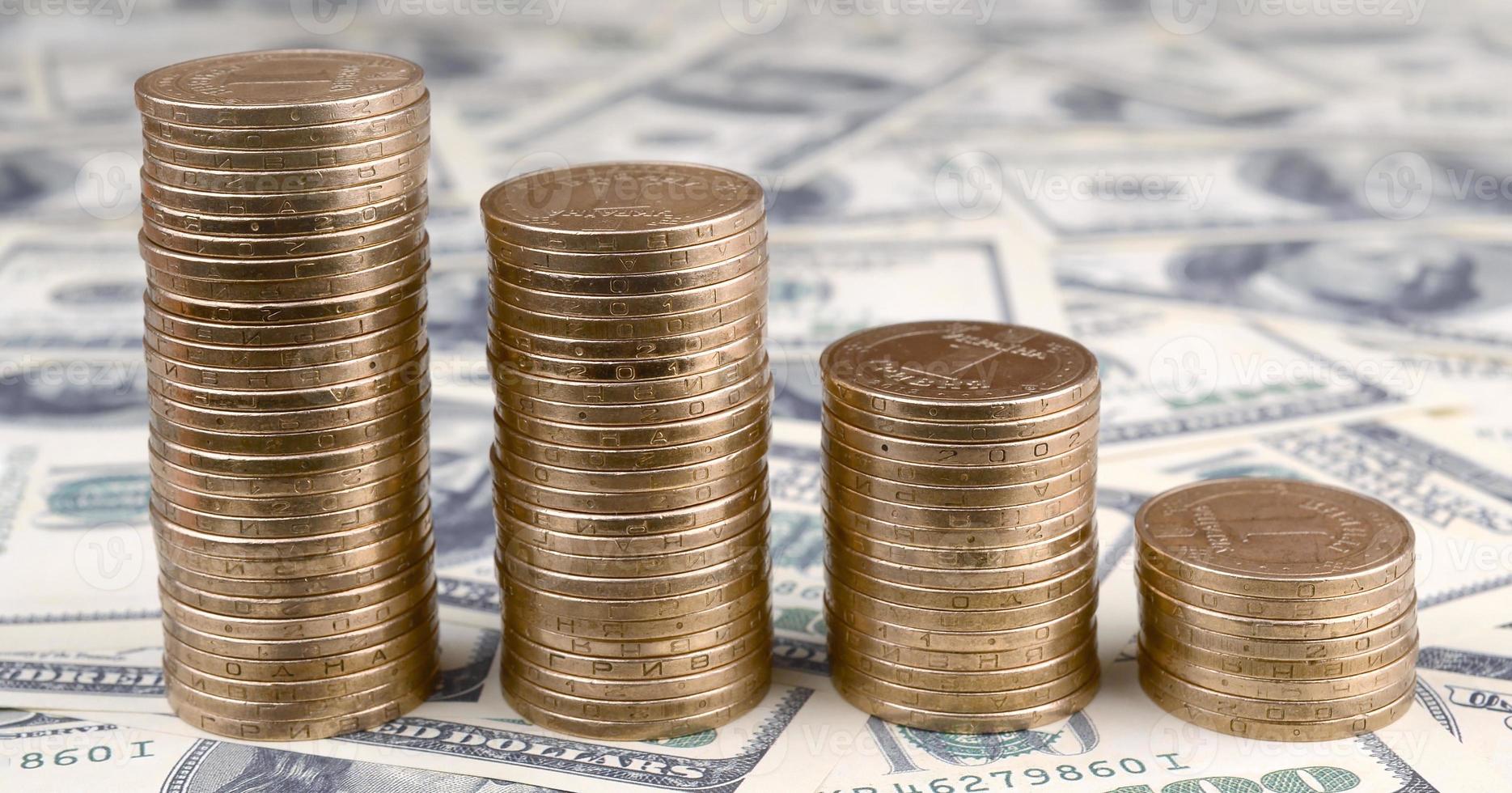 Ukrainian money lies on many US hundred dollar bills photo