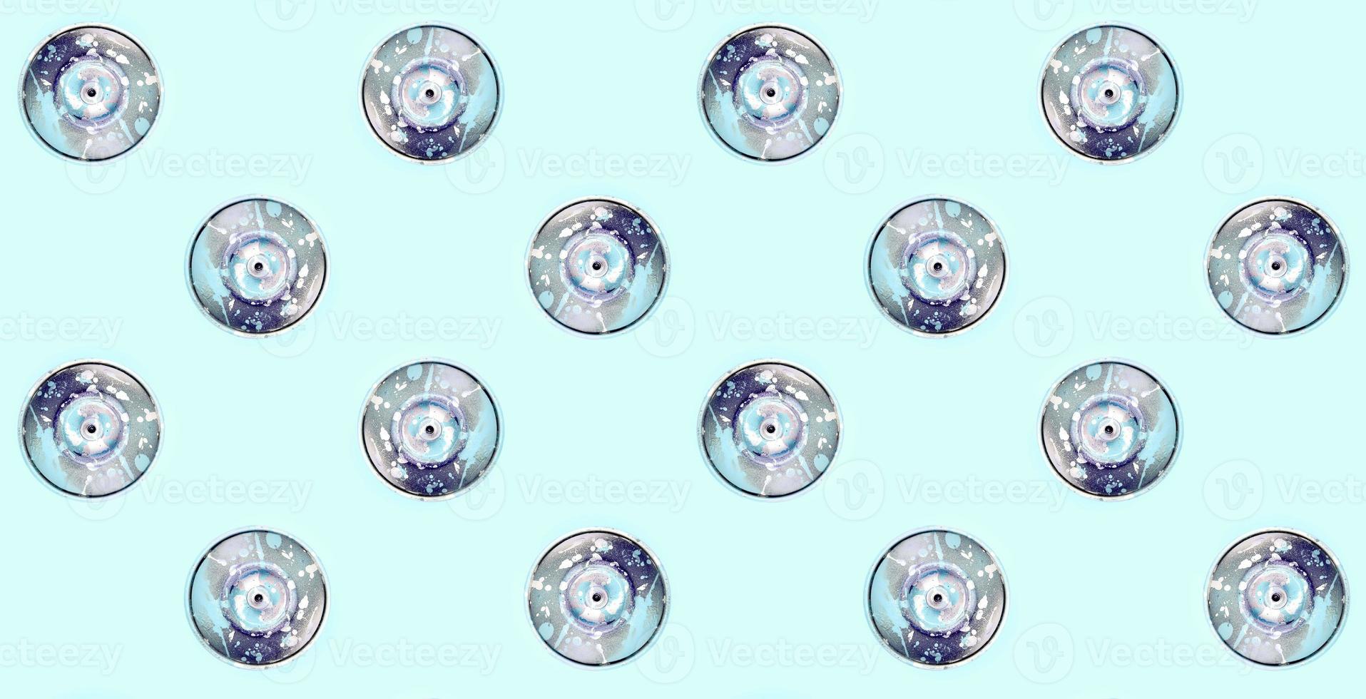 Many used spray cans for graffiti drawing lies on a pastel colored backgroung. Street art painting concept. Minimal flat lay pattern. Top view photo