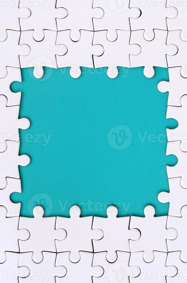 Framing in the form of a rectangle, made of a white jigsaw puzzle around the blue space photo