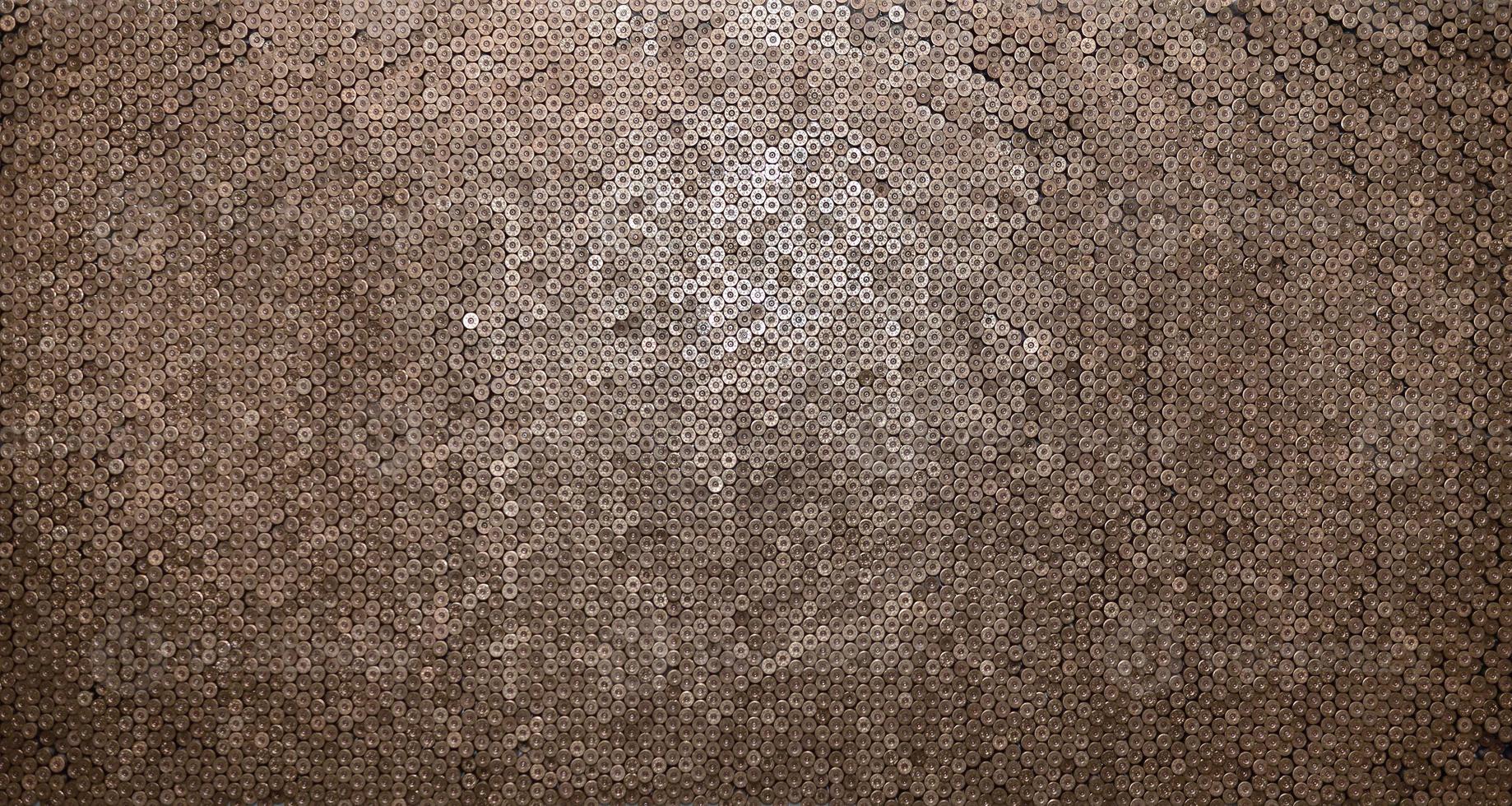Pattern of 12 gauge cartridges for shotgun bullets. Shells for hunting rifle close up. Backdrop for shooting range or ammunition trade concepts photo