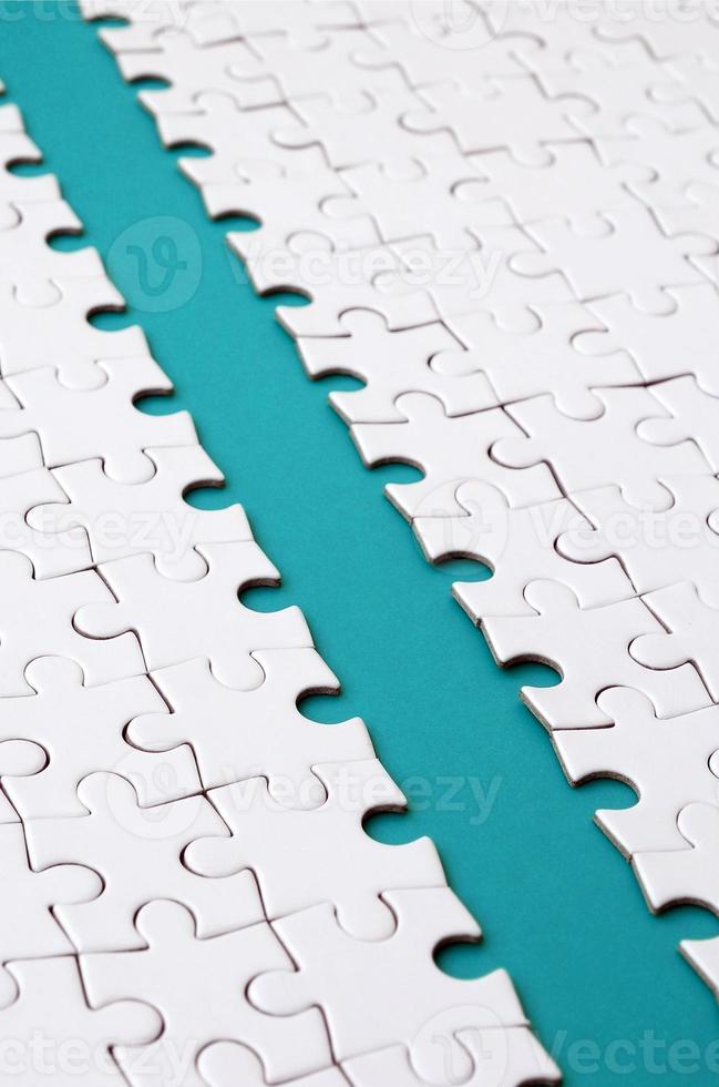 The blue path is laid on the platform of a white folded jigsaw puzzle. Texture image with copy space for text photo