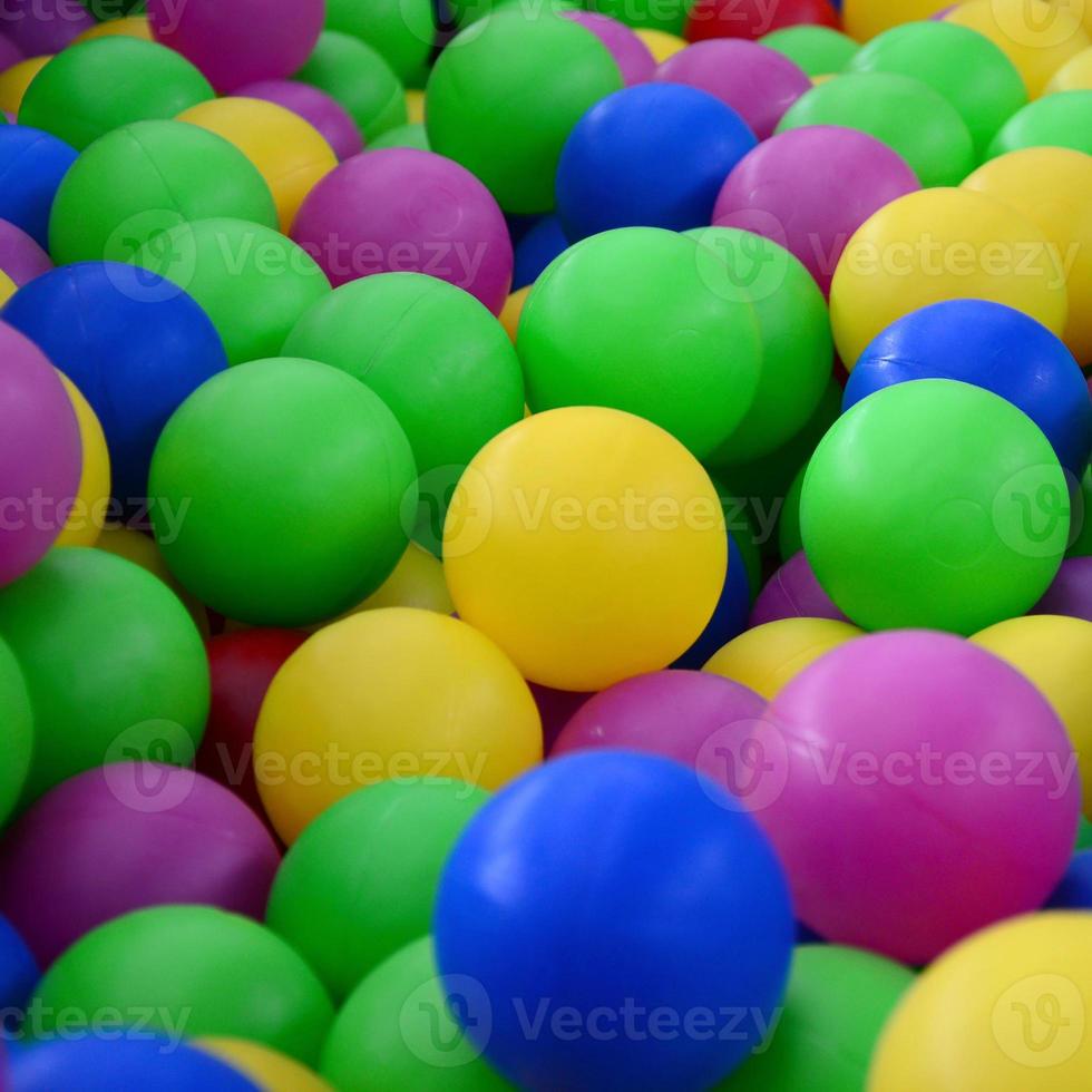 Swimming pool for fun and jumping in colored plastic balls photo