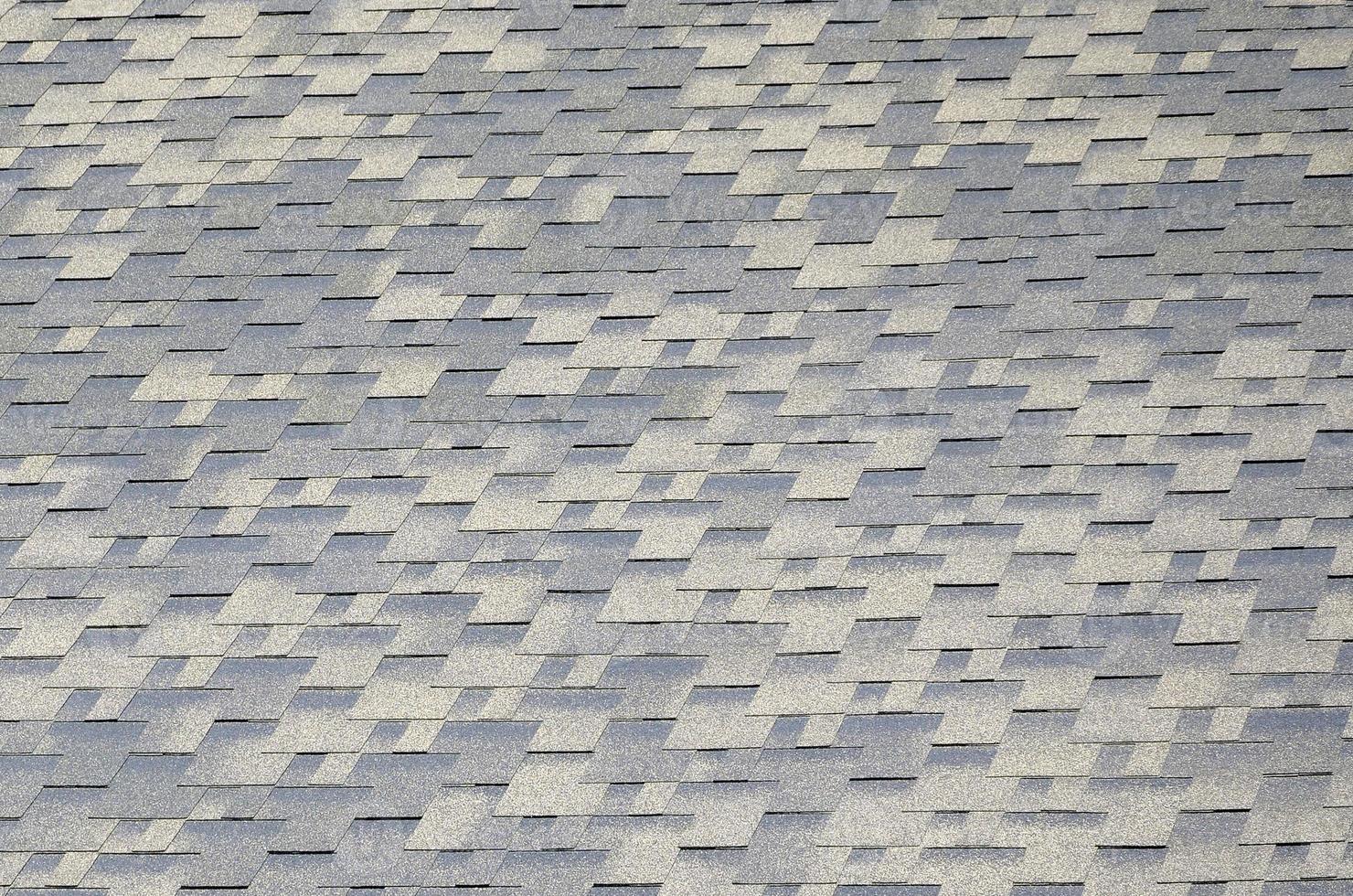 Background mosaic texture of flat roof tiles with bituminous coating photo