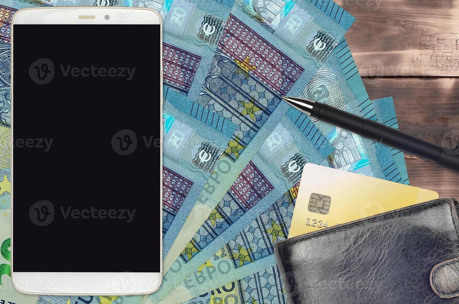 20 euro bills and smartphone with purse and credit card. E-payments or e-commerce concept. Online shopping and business with portable devices photo