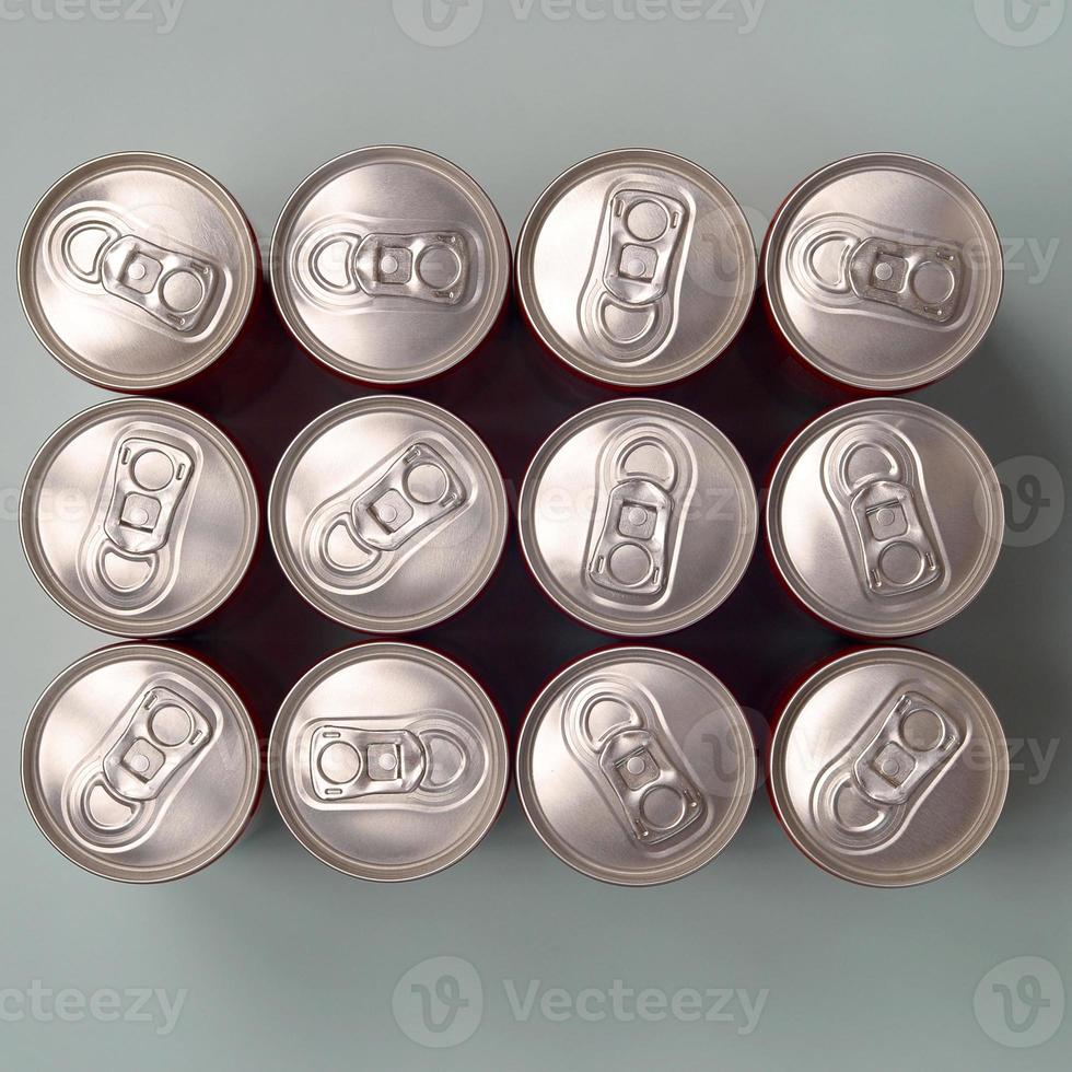 Many new aluminium cans of soda soft drink or energy drink containers. Drinks manufacturing concept and mass production photo