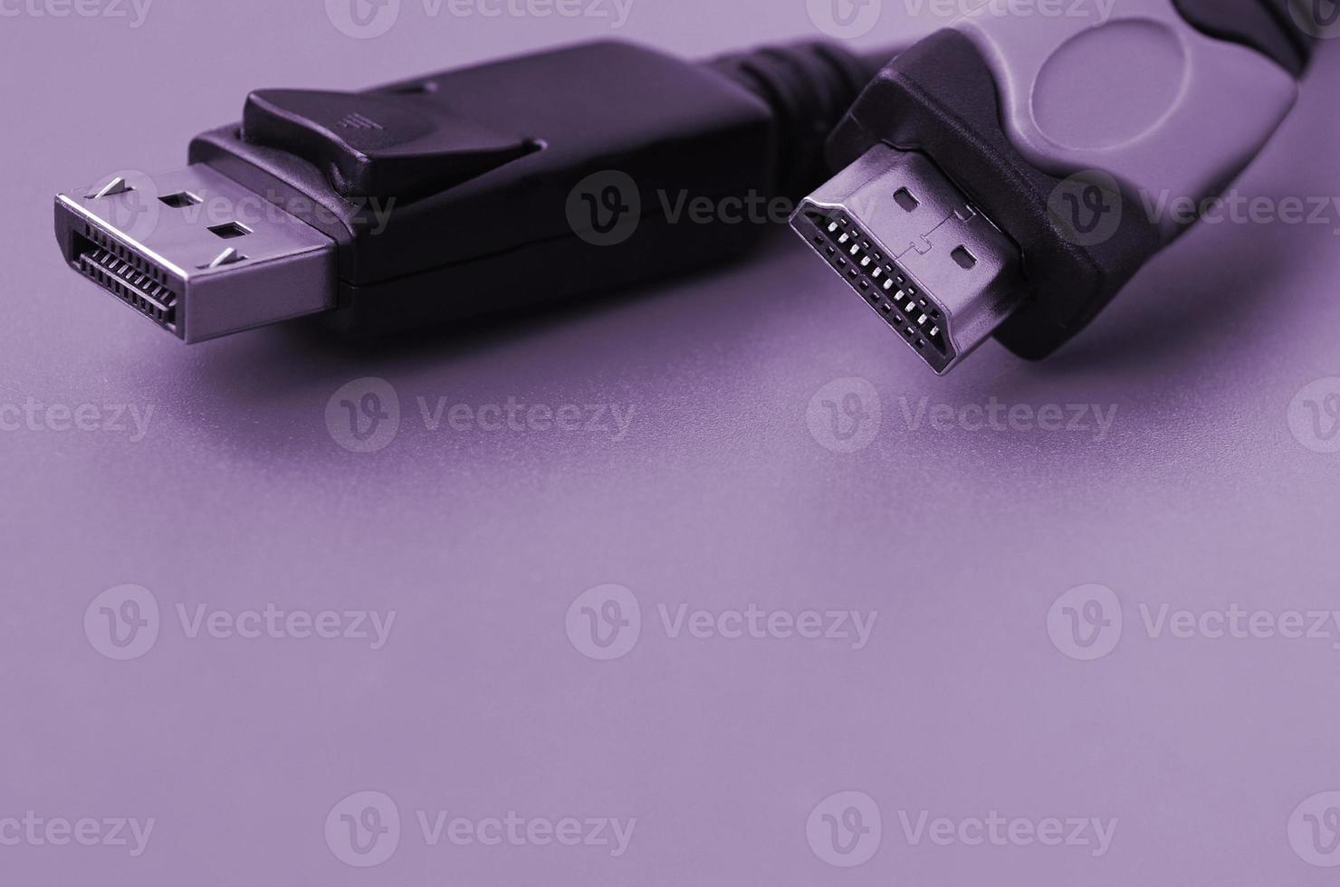 Audio video HDMI computer cable plug and 20-pin male DisplayPort gold plated connector for a flawless connection on purple backdrop photo