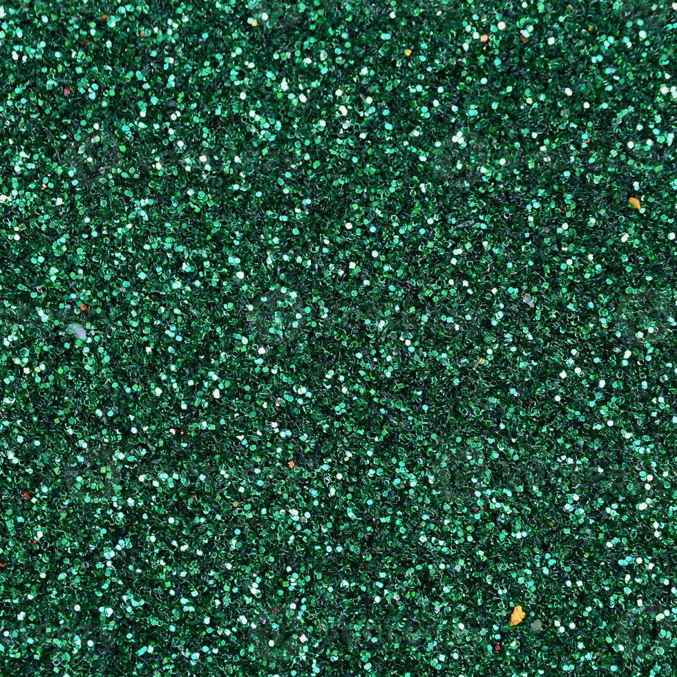 Colorful defocused emerald green background with glittering and sparkling spots photo