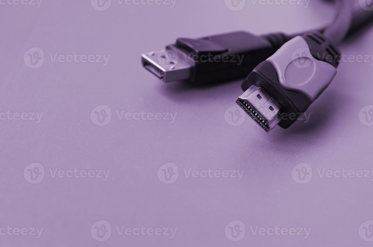 Audio video HDMI computer cable plug and 20-pin male DisplayPort gold plated connector for a flawless connection on purple backdrop photo