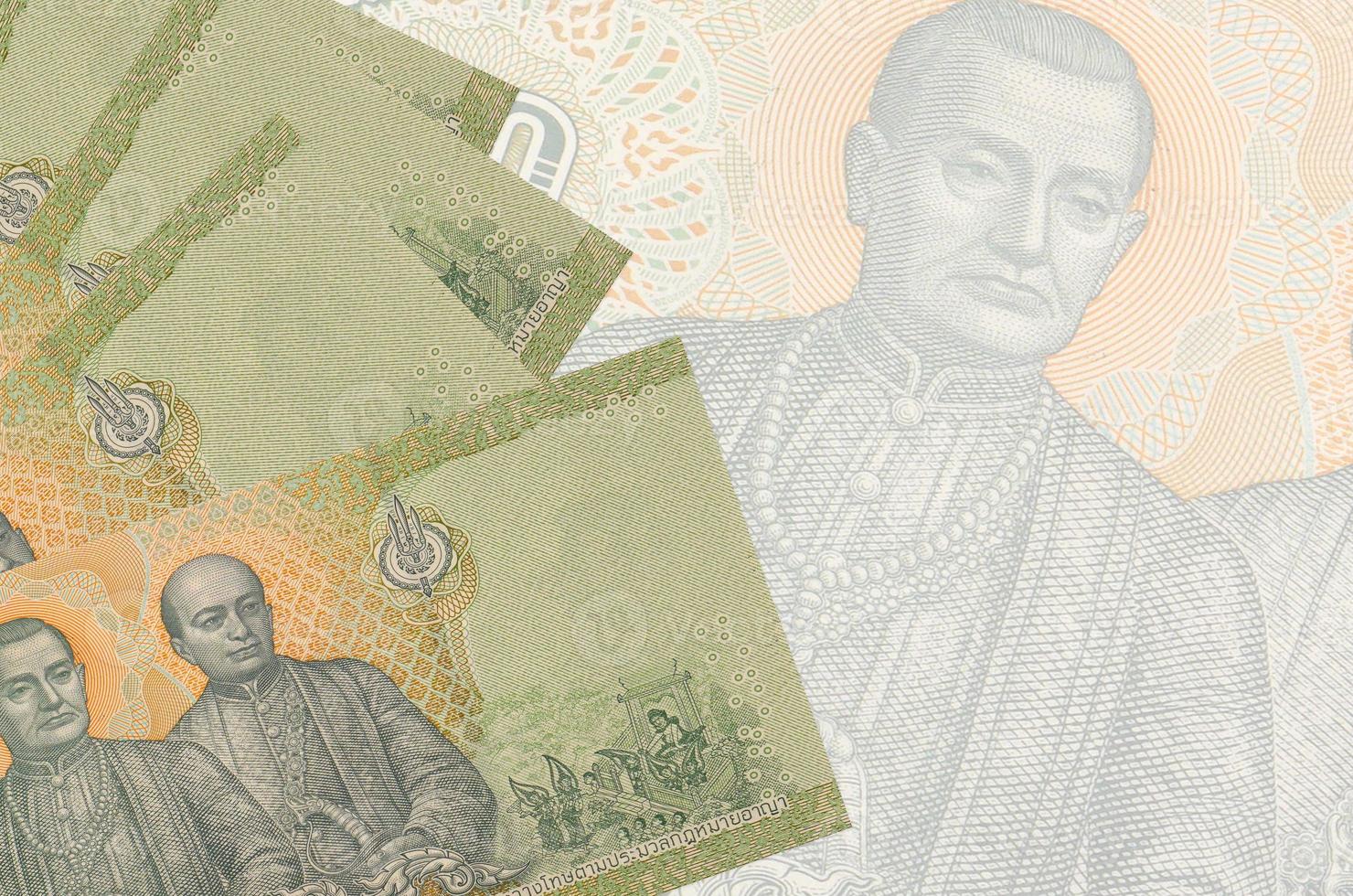 20 Thai Baht bills lies in stack on background of big semi-transparent banknote. Abstract business background photo