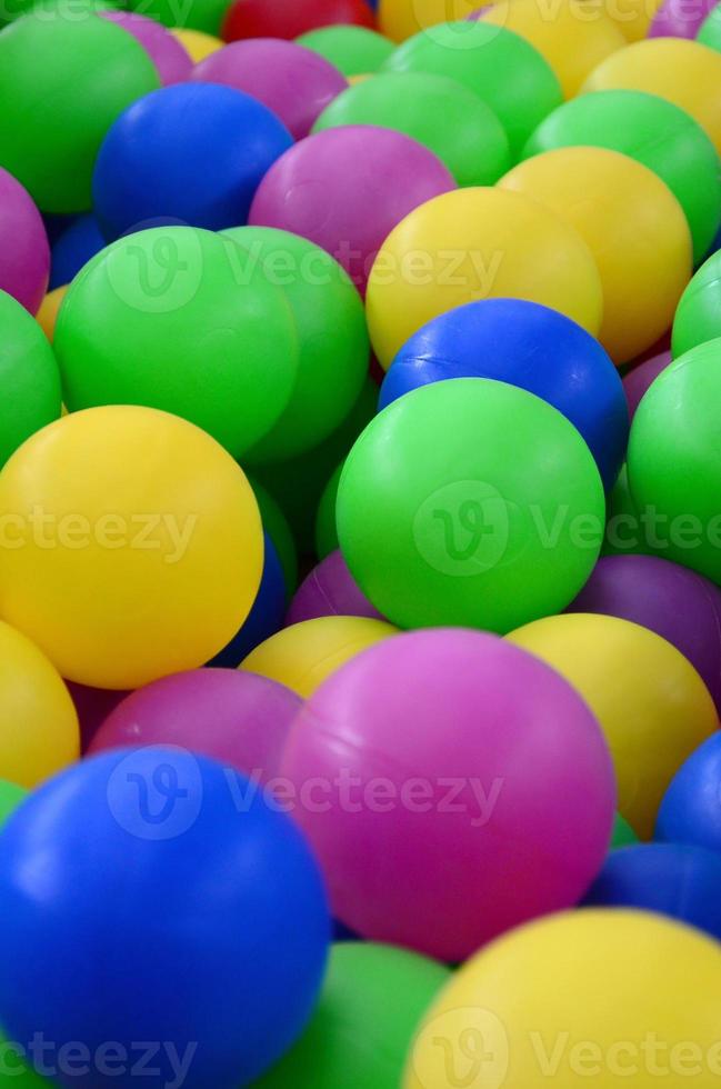 Swimming pool for fun and jumping in colored plastic balls photo