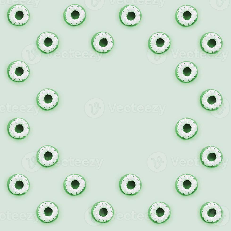 Many small plastic donuts lies on a pastel colorful background. Flat lay minimal pattern. Top view photo