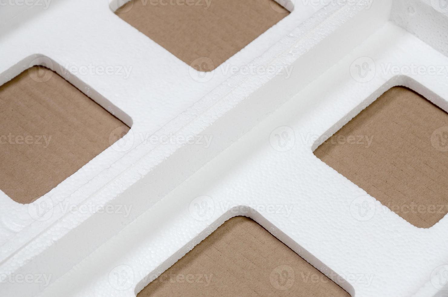 Background image with beige cardboard paper and styrofoam boxes disgarded as rubbish. The concept of unpacking new home appliances out of the carton box photo