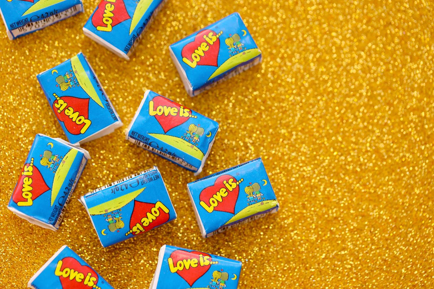 TERNOPIL, UKRAINE - JUNE 23, 2022 Love is - turkish bubble gums from 1990s popular in russian region. Various flavors of Love is chewing gum with liners about love photo